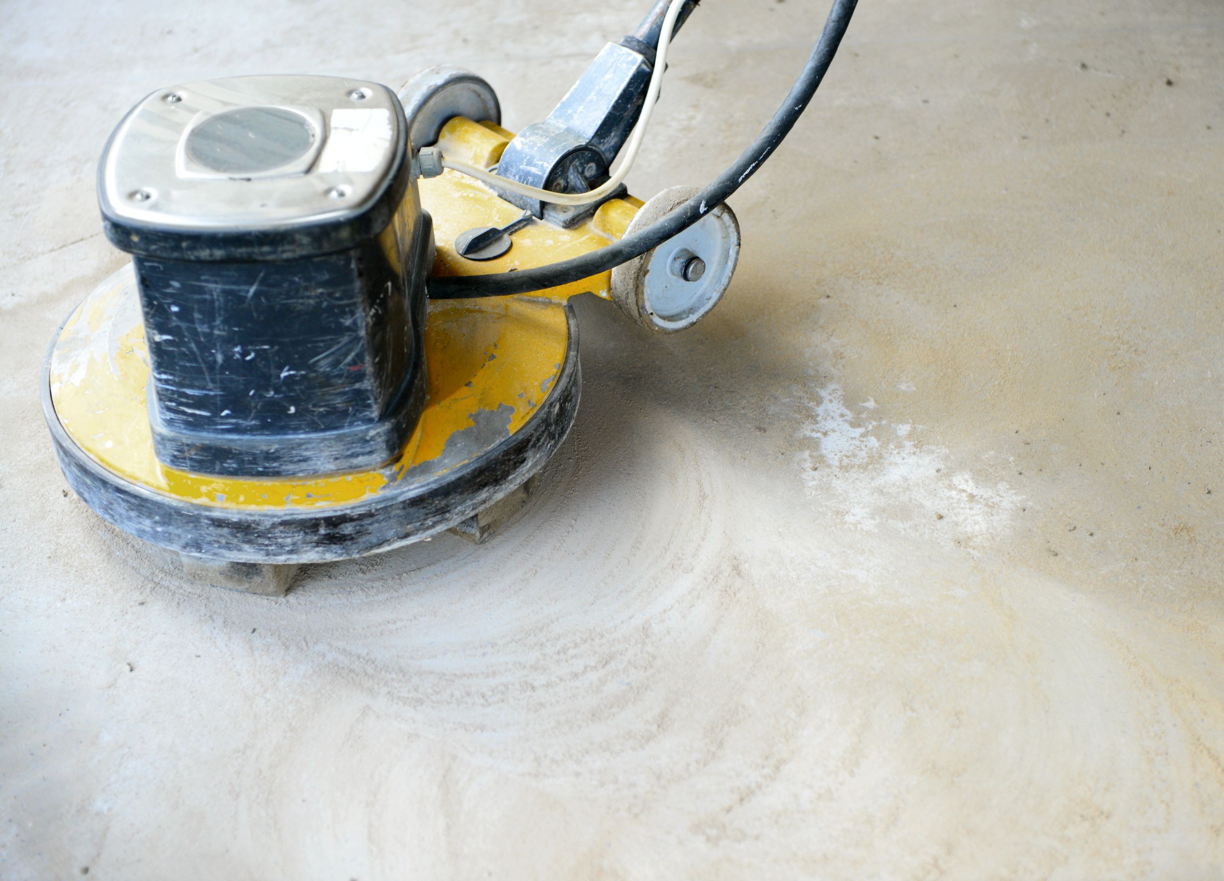 A floor scrubber is cleaning the floor.