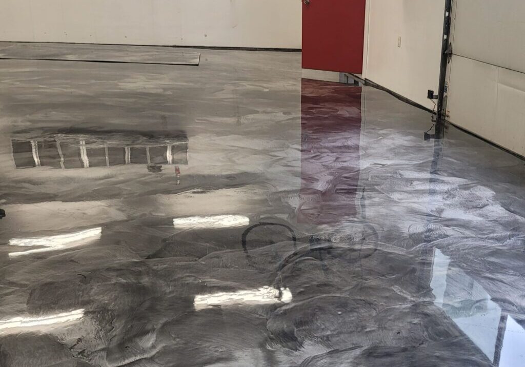 A room with a red door and a metallic floor
